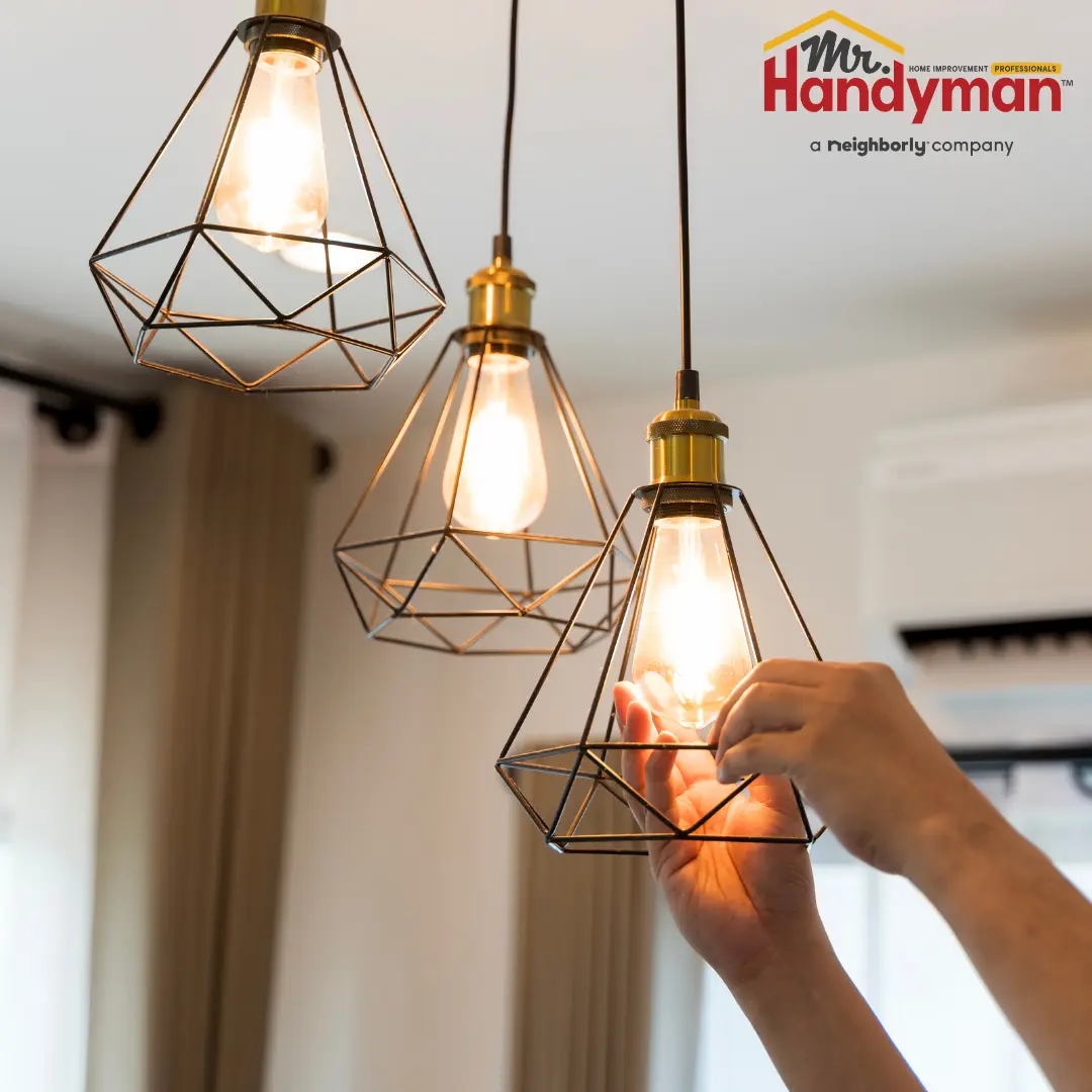 A person holding a light bulb in their hand.