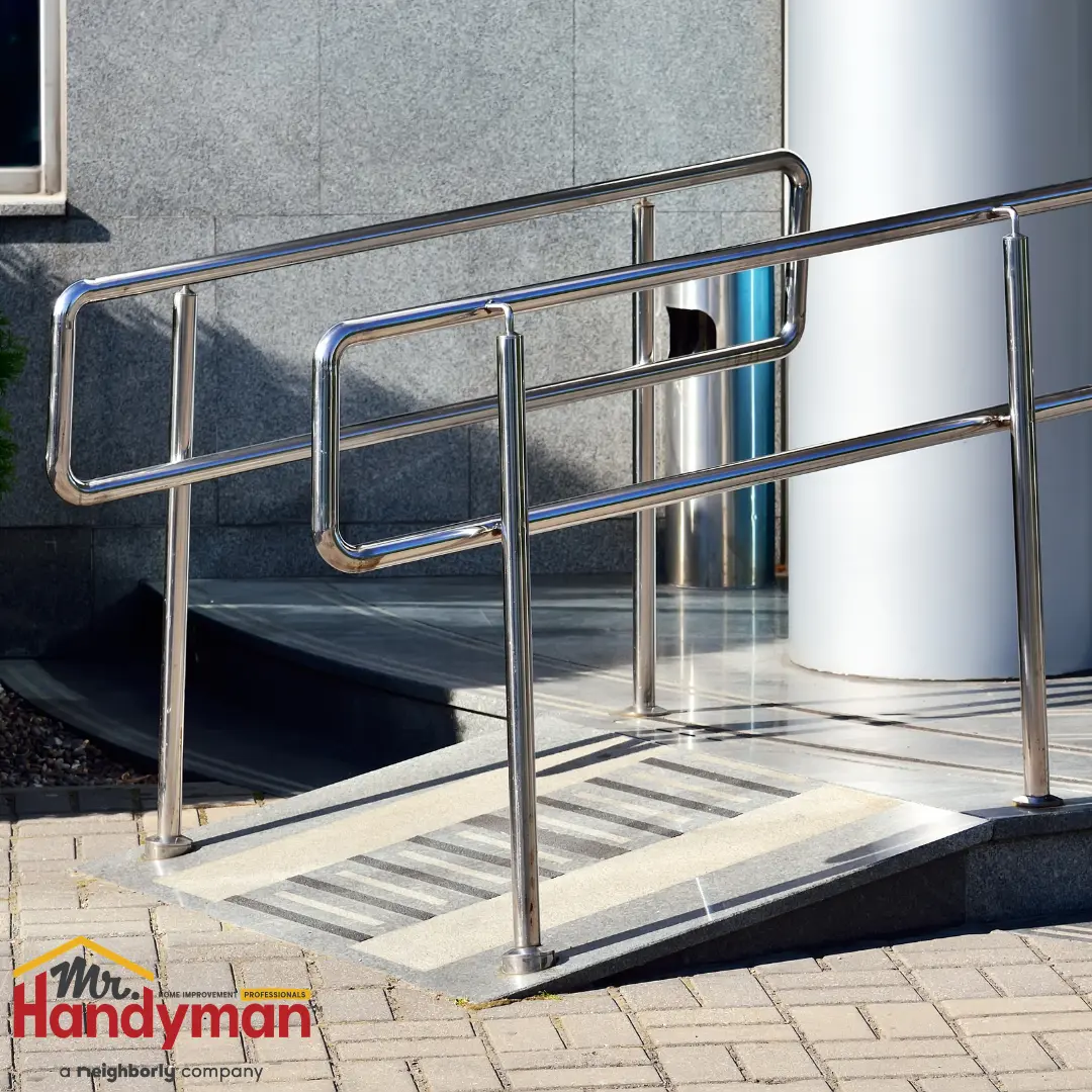 A metal ramp with handrails leading to a building entrance.