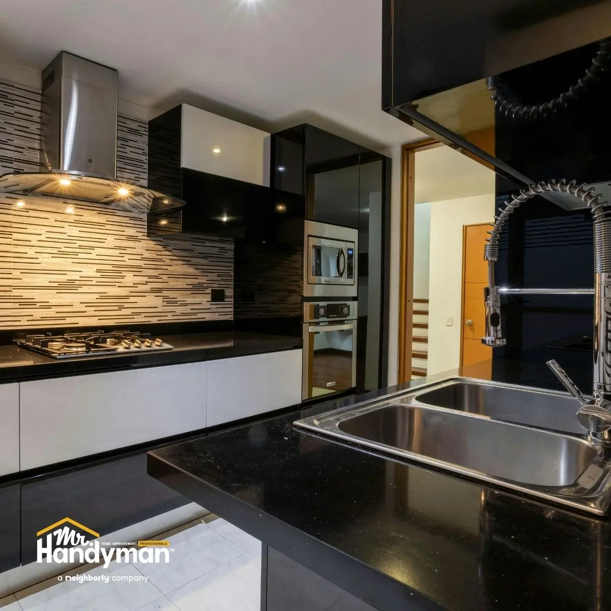 Mr. Handyman technician installing a new kitchen faucet and plumbing fixtures in a Nashville home