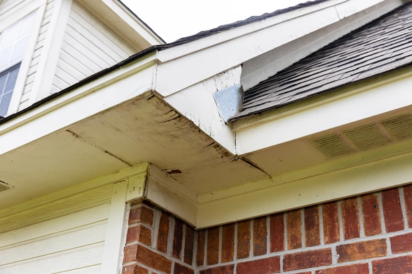 A close-up view of a house's eaves and gutters.