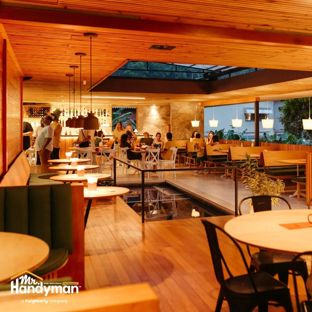 Warm, inviting restaurant interior with wooden decor, pendant lights, and cozy seating areas.