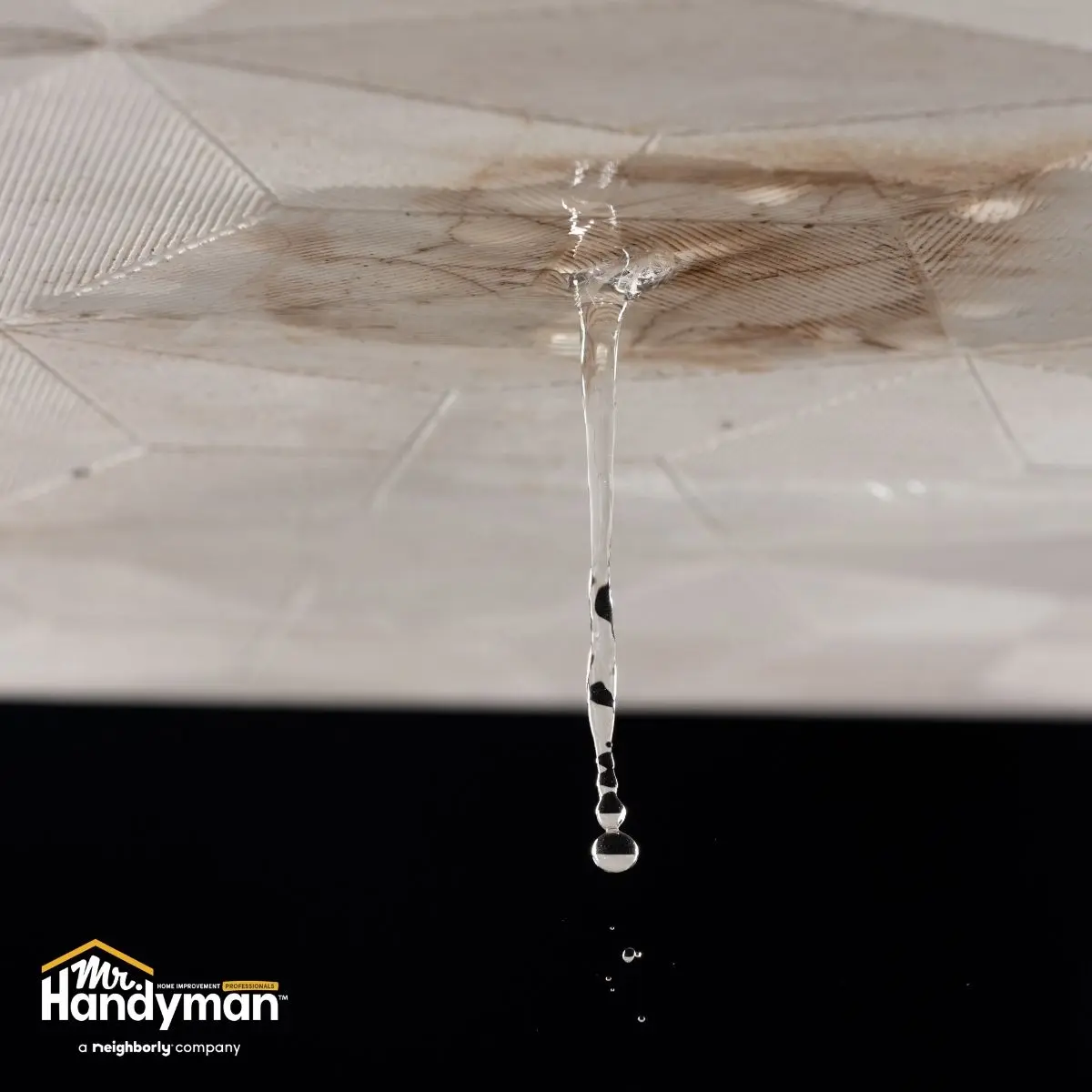 technician inspecting water damage on ceiling in Wichita home