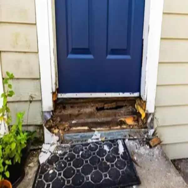 Front stoop with wood rot.