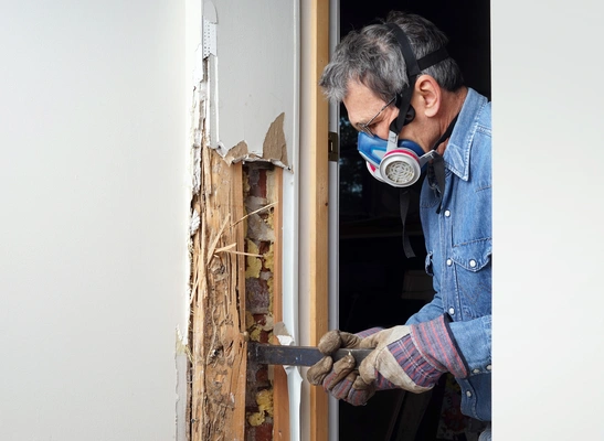 Repairing wood rot on door.
