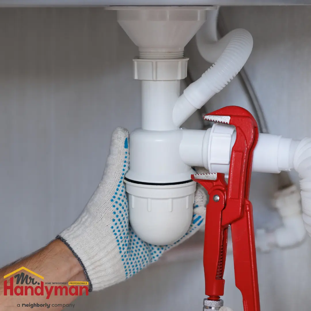 Mr. Handyman technician repairing a leaking faucet and inspecting supply lines in a Murfreesboro, Tennessee