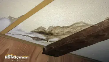 handyman inspecting ceiling and wall for water damage in Oklahoma City OK home