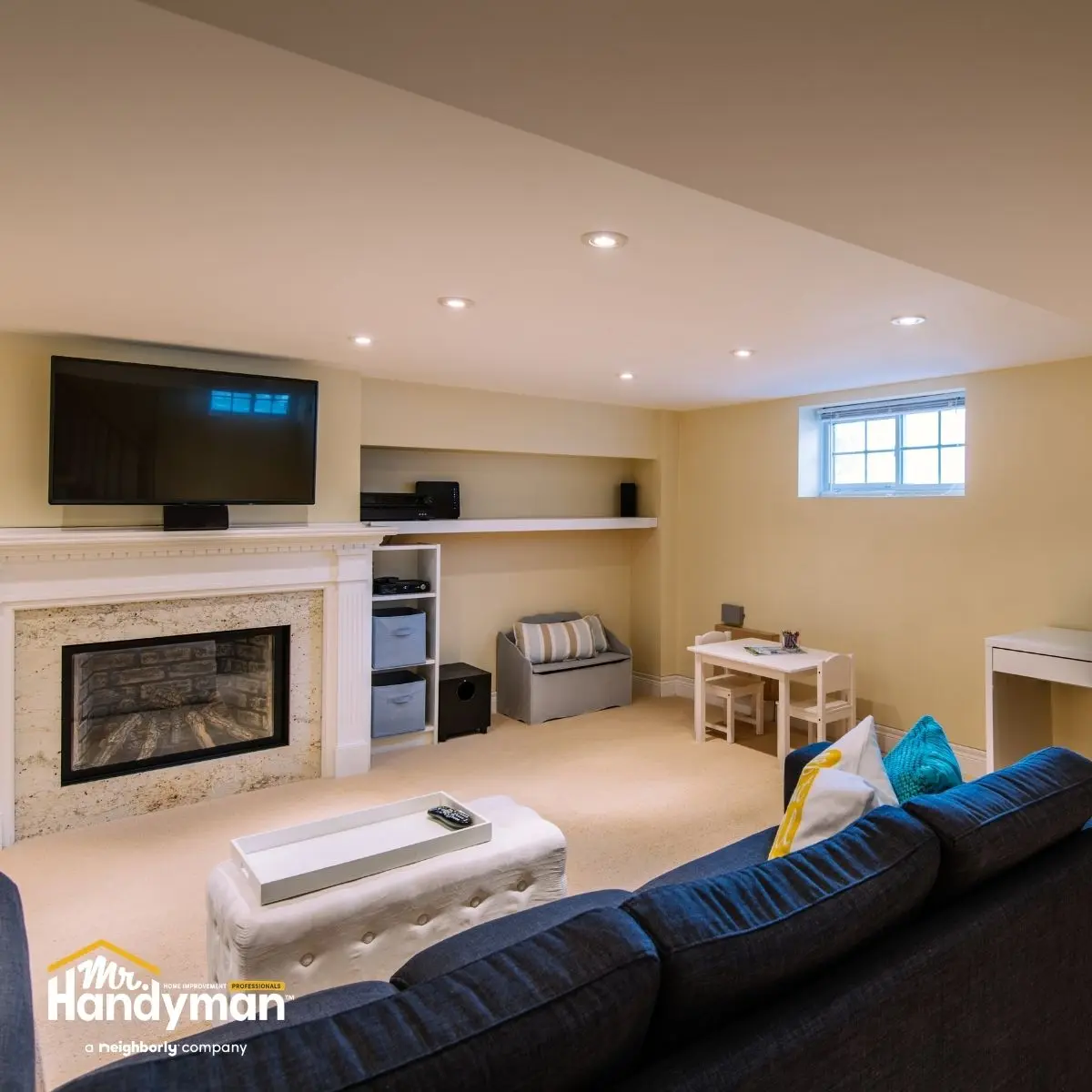 Bright basement living area featuring a TV, fireplace and comfortable seating.