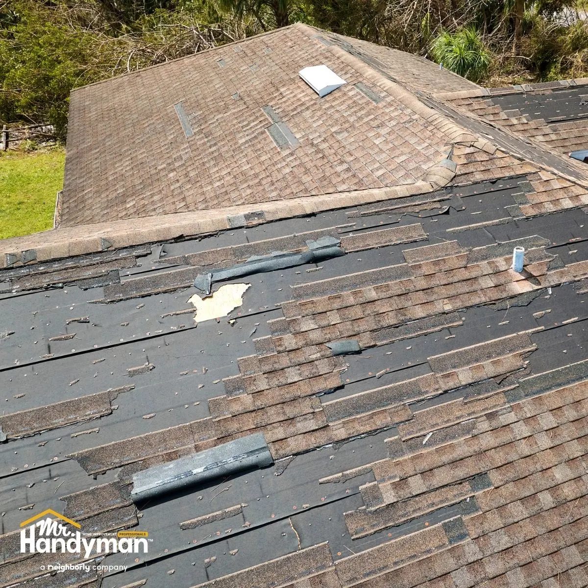 A damaged roof with missing shingles.