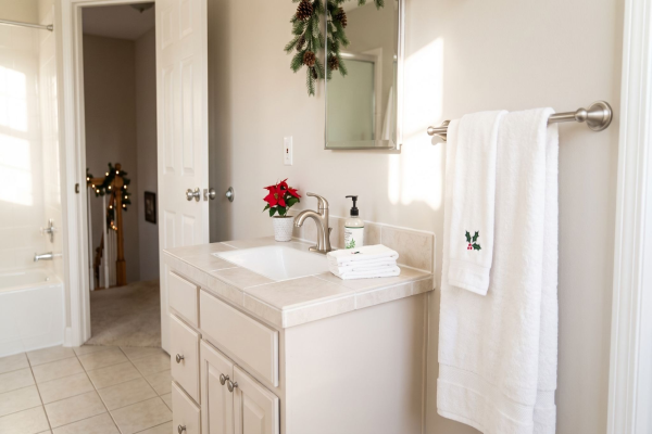 A festive bathroom showing handyman upgrades like new faucet, updated fixtures, and refreshed caulk and grout.