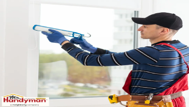 Handyman inspecting a commercial rooftop for storm damage in Cedar Hill Texas.