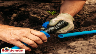 hands connecting blue irrigation pipes.