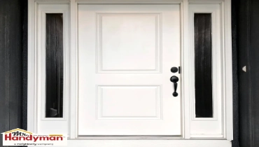 Handyman painting a front door to boost curb appeal at a home in West Nashville Tennessee
