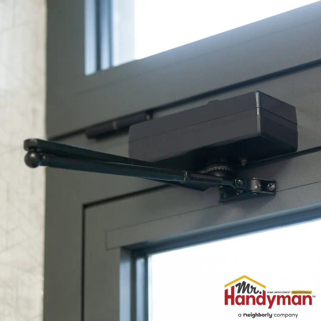 handyman repairing a commercial entrance door closer