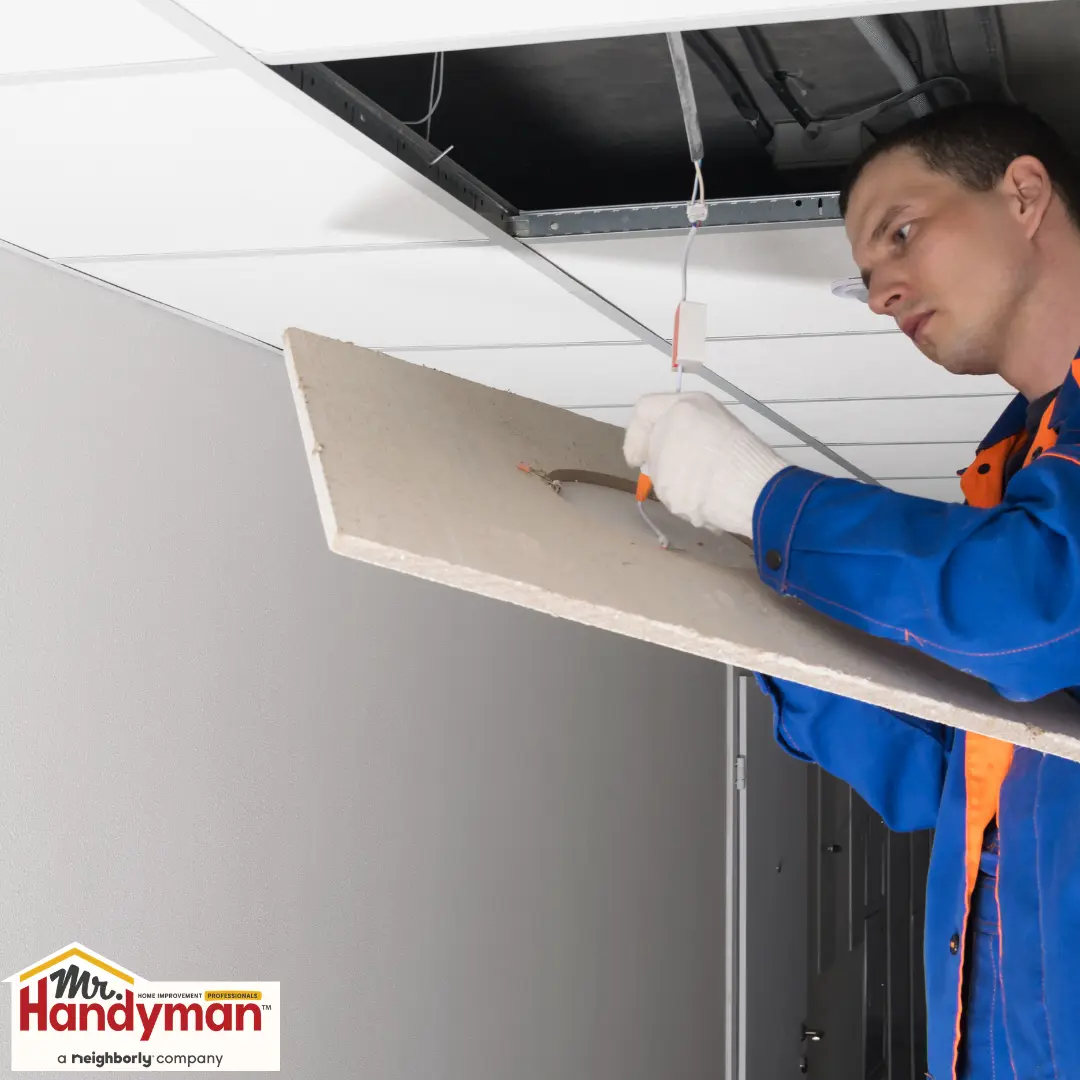 replacing stained ceiling tiles in a commercial space.
