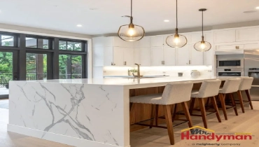 Mr. Handyman technician installing kitchen island cabinetry in home ahead of summer entertaining season