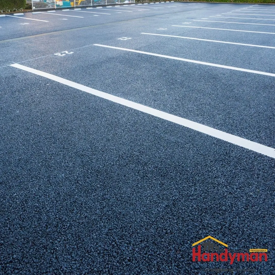 An empty asphalt parking lot.