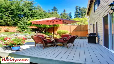 Handyman staining and restoring a wood deck before the outdoor season in Martinsburg West Virginia.