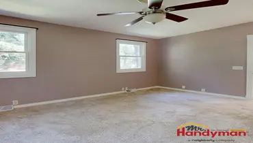 Handyman installing crown molding in a living room in Martinsburg West Virginia.