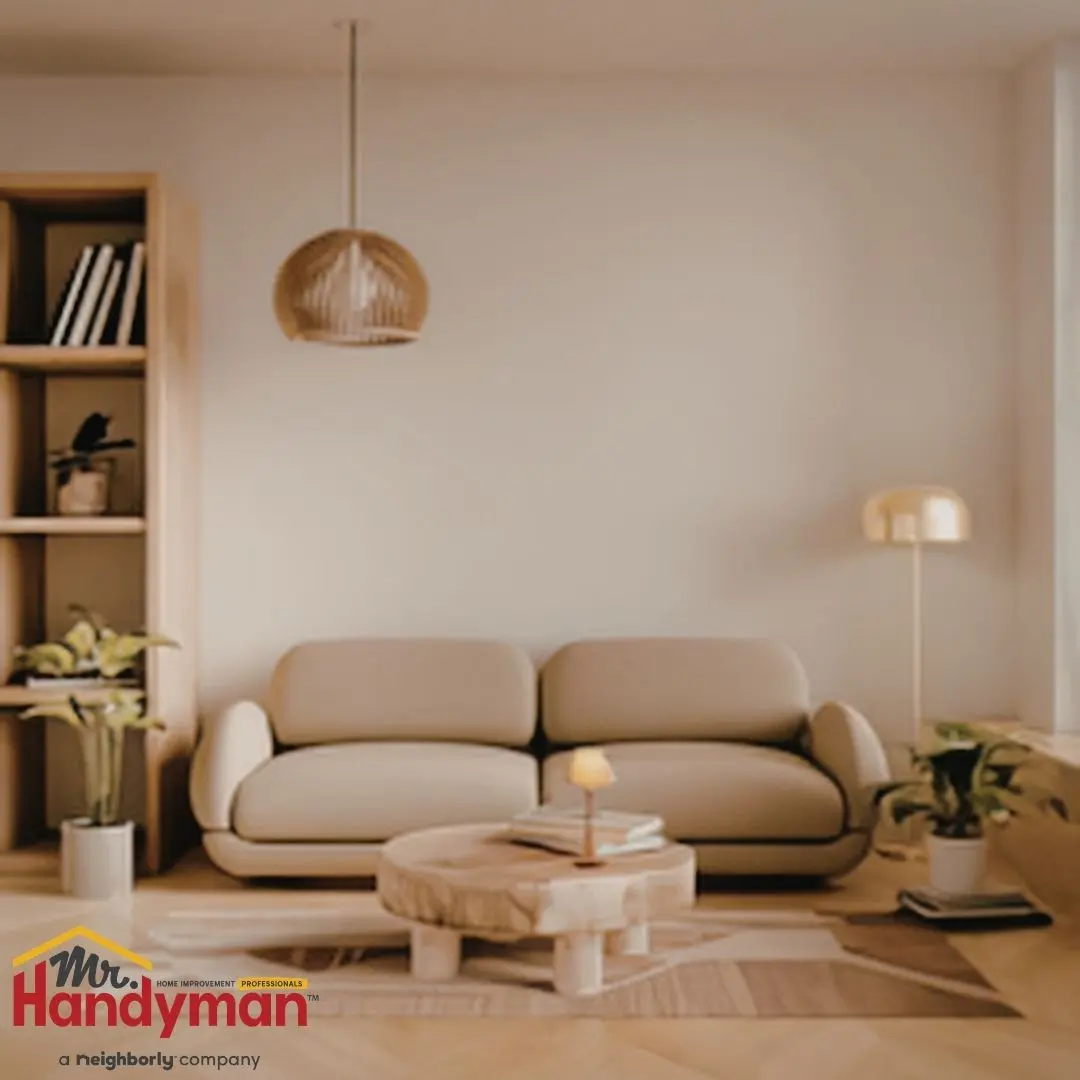 A beige sofa sits in a minimalist living room with a wooden coffee table and shelving.