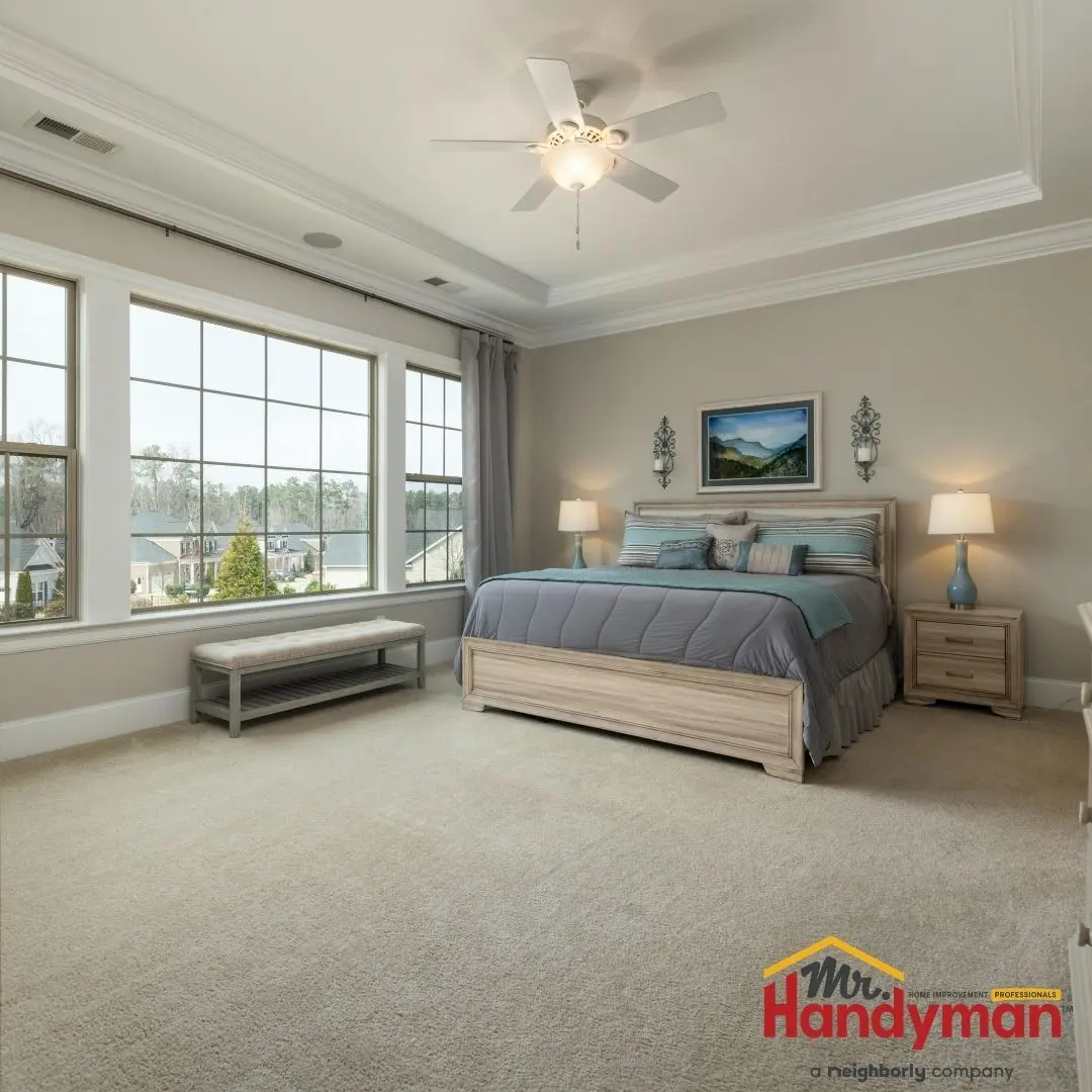 A bedroom featuring a wooden bed with blue bedding.