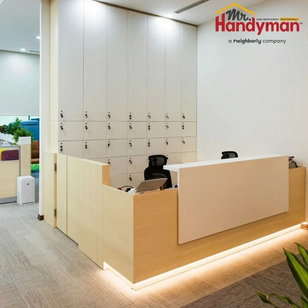 A modern reception desk featuring a white counter and wooden finishes.