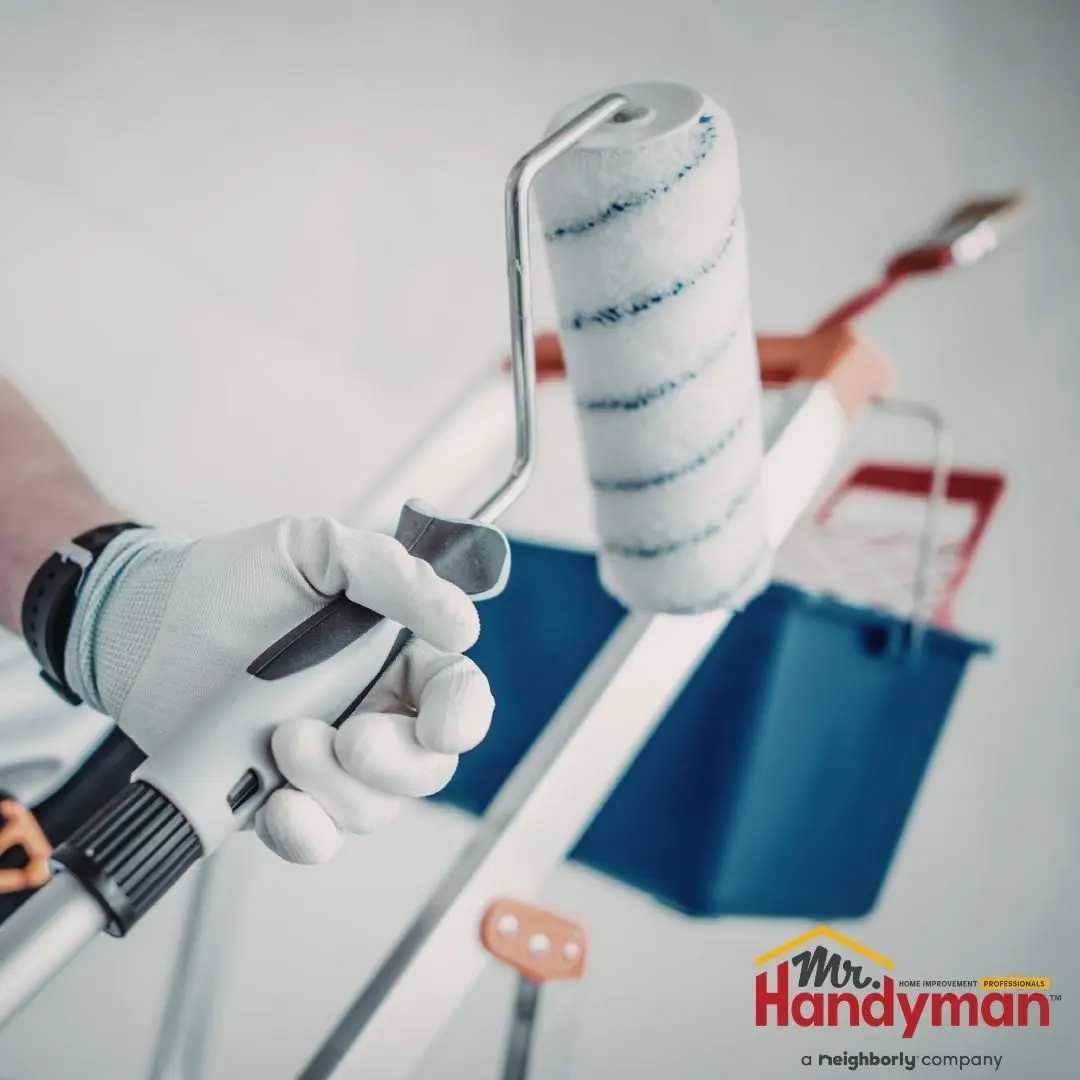 Handyman installing a new light fixture and hardware in a Rockwall, TX home