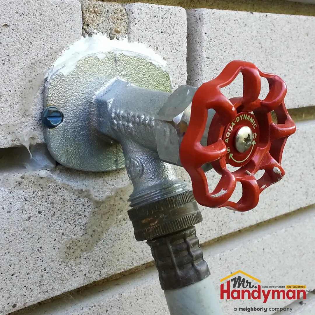 Handyman installing an outdoor hose bib on a West Nashville, TN home.