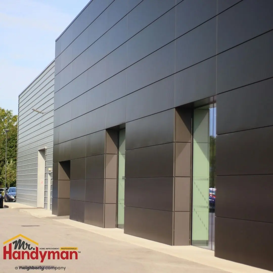 Mr. Handyman technician performing exterior maintenance and door repair on a commercial property in Plano, Texas.