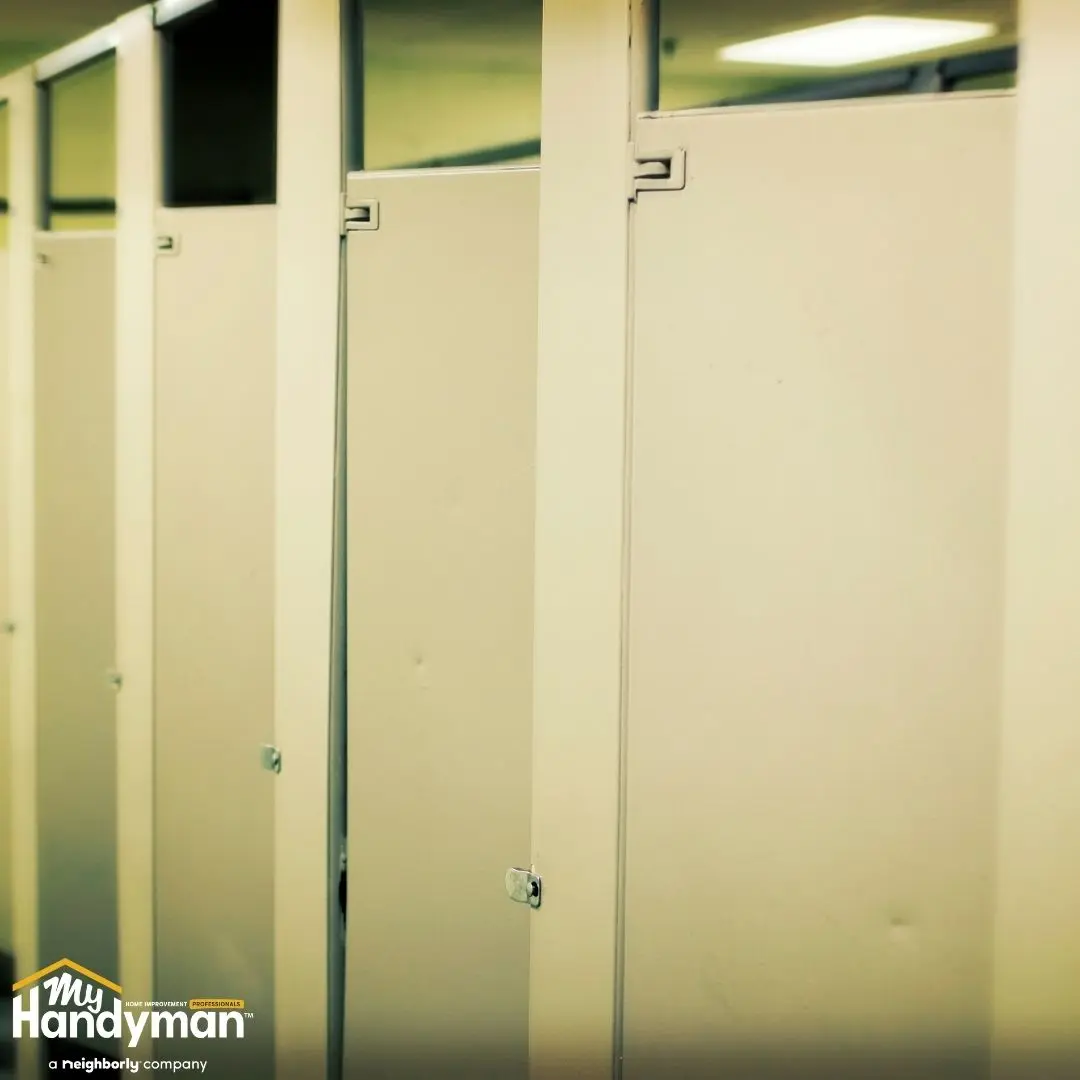 Rows of beige restroom stall doors.