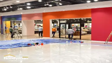 Mr. Handyman technician updating commercial interior with fresh paint and lighting in Martinsburg WV business