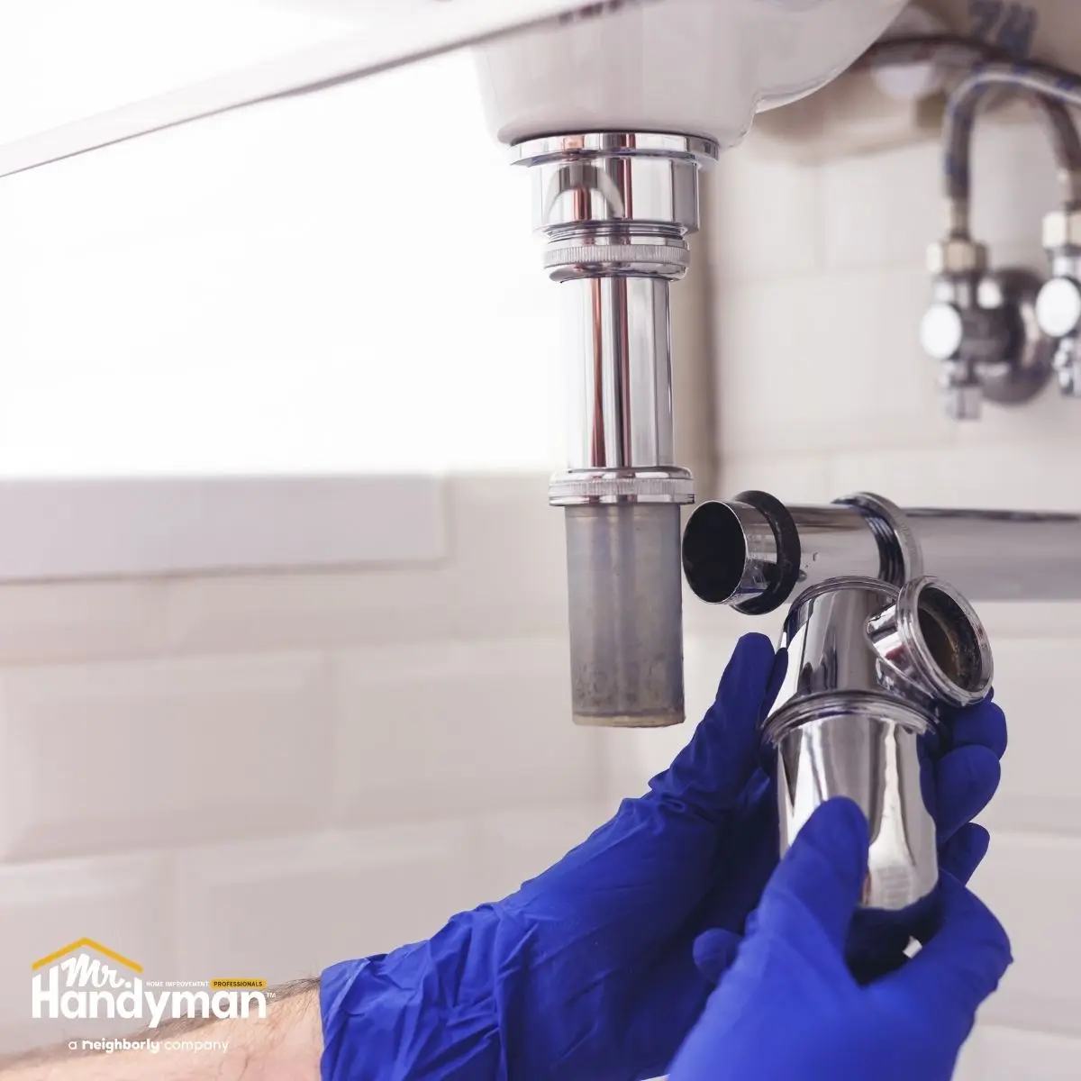 Mr. Handyman technician servicing locker room plumbing fixtures at a Nashville fitness facility
