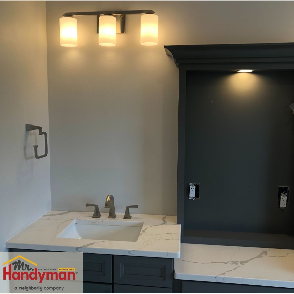 Bathroom vanity with modern triple light fixture installed by Mr. Handyman serving Citrus Park and Keystone