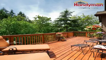 Handyman repairing a deck railing at a Mishawaka, IN home