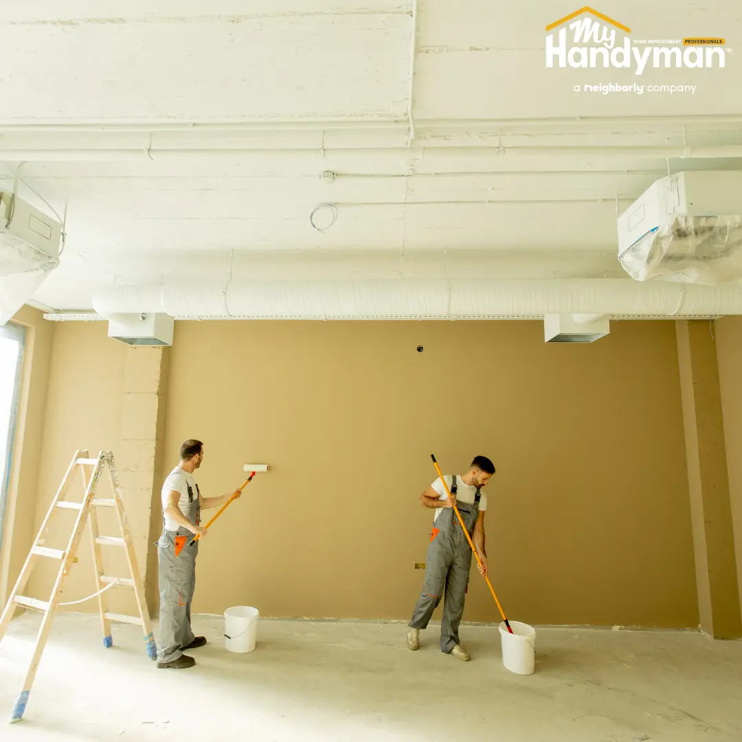 Handyman restoring a commercial entry floor and door hardware in Ann Arbor Michigan