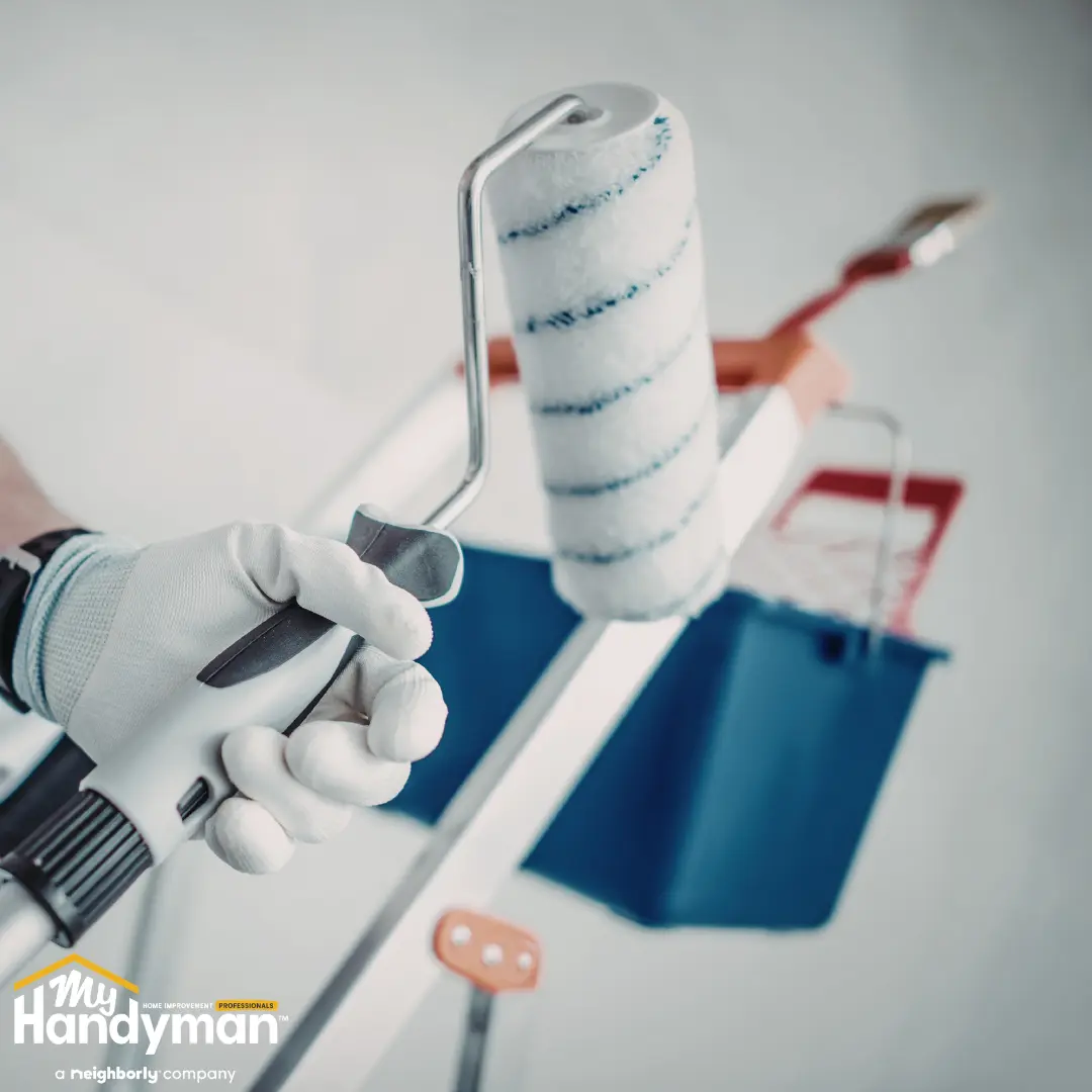 Handyman restoring a commercial entry floor and door hardware in Ann Arbor Michigan