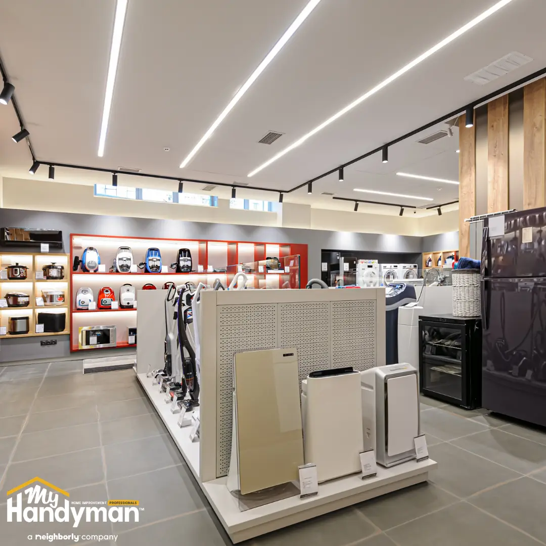 Handyman restoring a commercial entry floor and door hardware in Ann Arbor Michigan