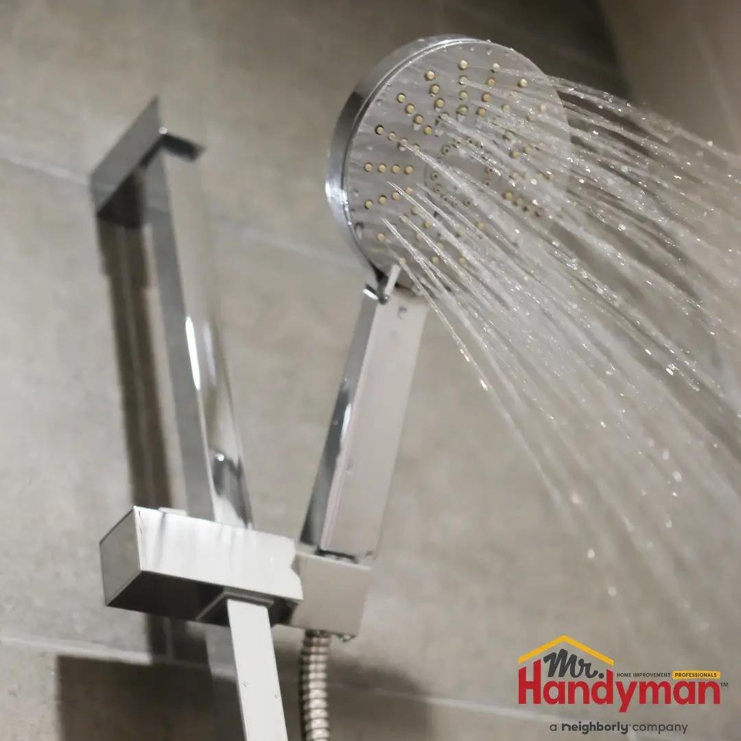 Mr. Handyman technician testing water pressure at a hose bib connection on a Murfreesboro, Tennessee home during summer