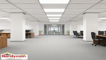 Handyman replacing stained ceiling tiles in a commercial space in Cedar Hill Texas