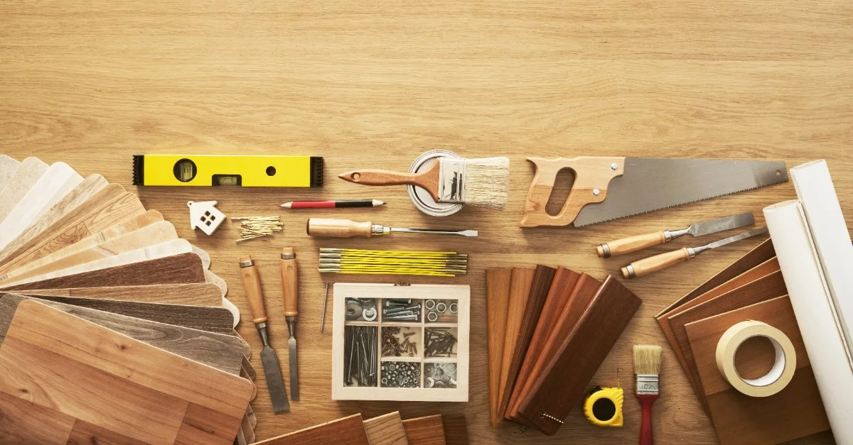 A wooden surface covered by tools and materials commonly used by a professional handyman in Darien, CT.
