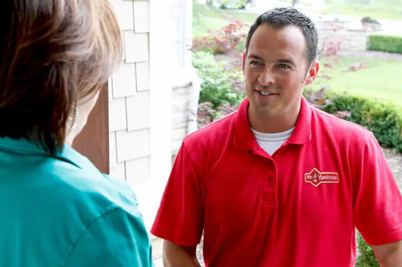 Handyman standing near pool with customer