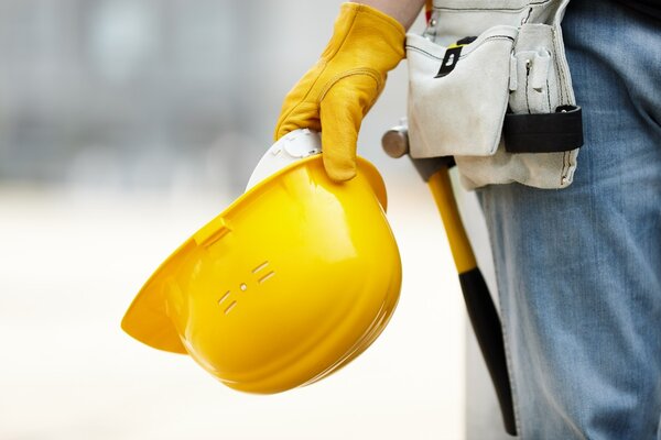 Handyman holding helmet on way to home renovation service in Lehi.
