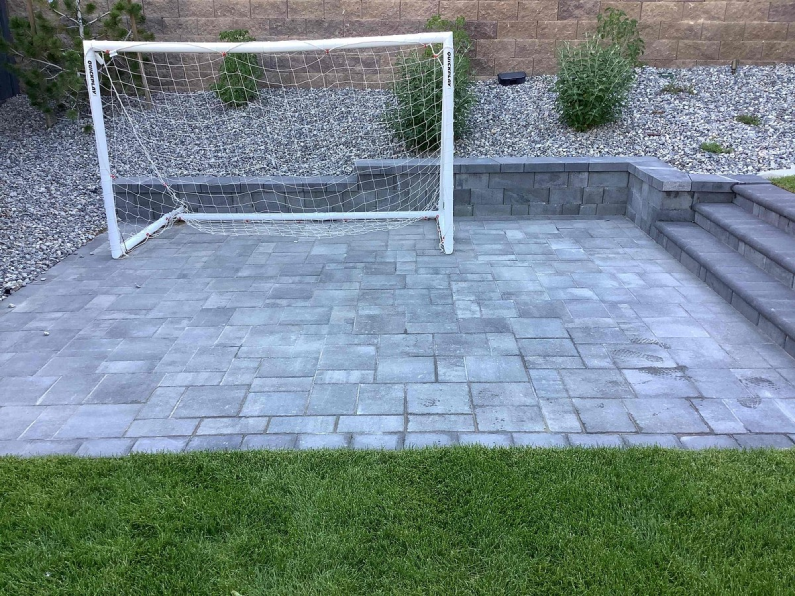A backyard with fresh stone tiles installed by a qualified handyman in American Fork