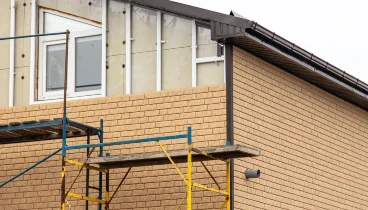 Scaffolding set up in front of a home for a professional house siding repair project