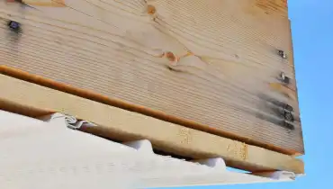 A close-up of the side of a residential roofline with missing fascia that has been removed during an appointment for fascia repair.