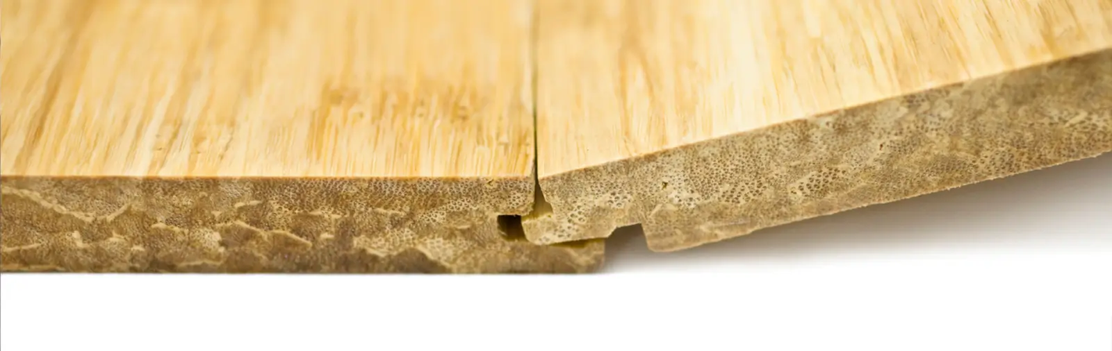 Two pieces of bamboo flooring being attached to each other