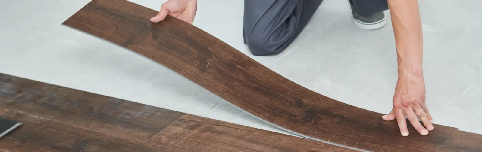 A plank of vinyl flooring being installed