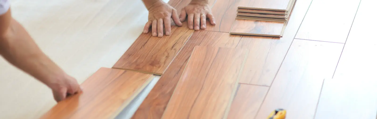 Wooden laminate flooring panels being installed