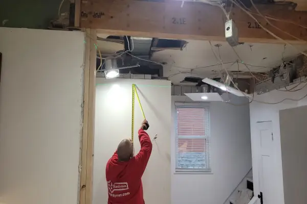 Mr. Handyman technician repairing drywall in Cincinnati home