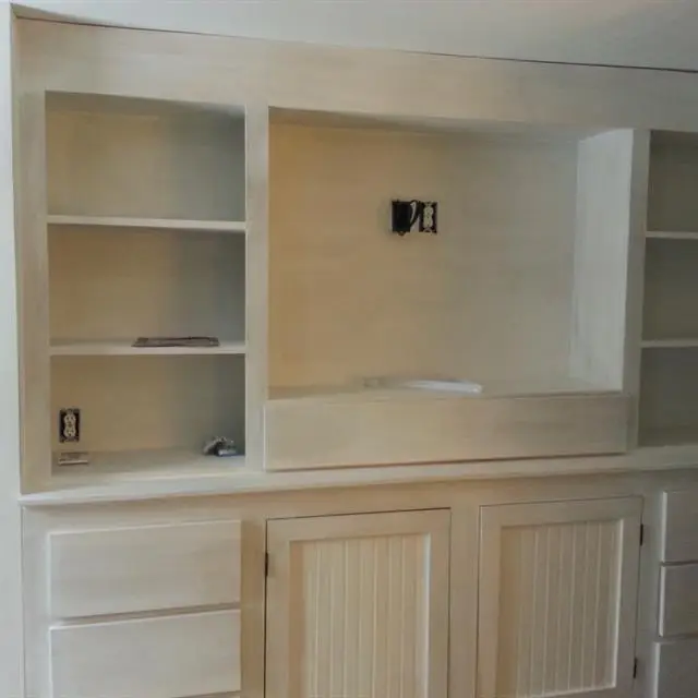 A custom-made entertainment center created for the living room of a home by Norfolk carpenters from Mr. Handyman.