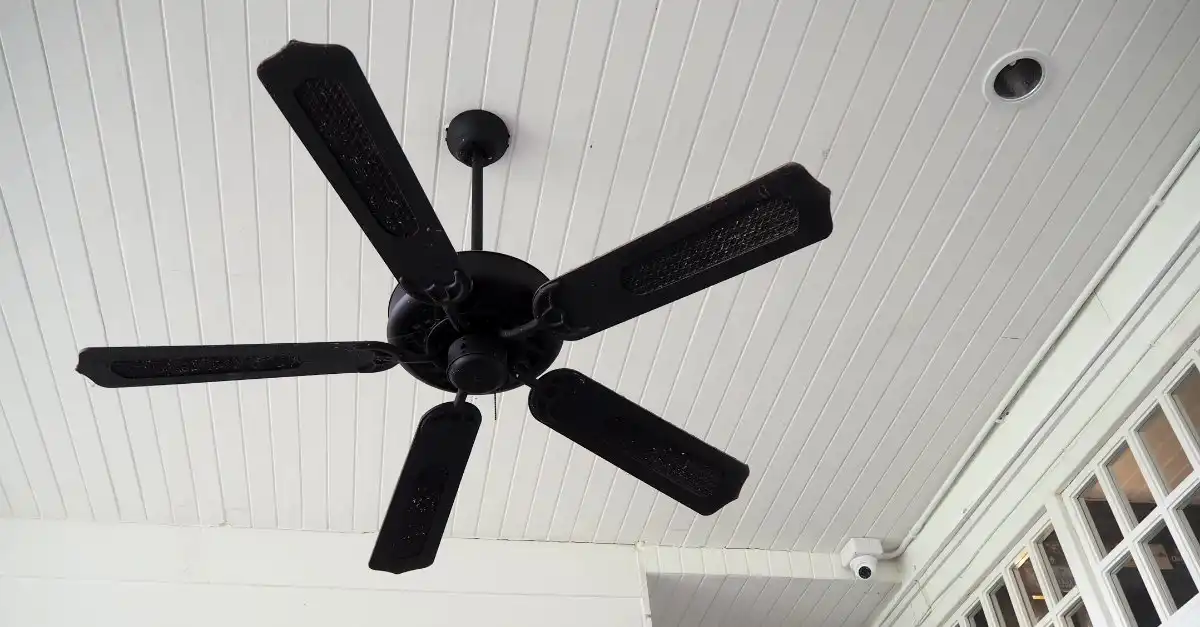 A black, 5-blade ceiling fan with mesh grates on each blade installed on a ceiling in an exterior area of a home in Lehi, UT.